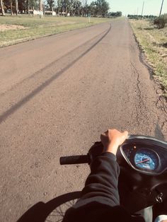 a person riding a motorcycle down a dirt road