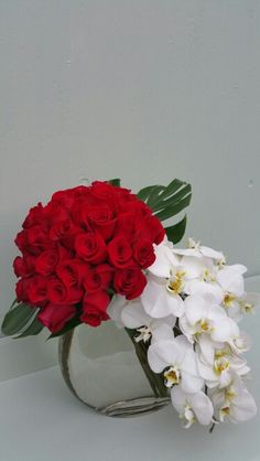 red roses and white orchids in a vase