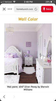 a bedroom with purple walls and white furniture