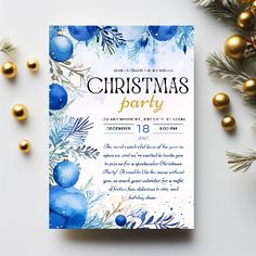 a christmas party flyer with blue ornaments and greenery on the table next to it