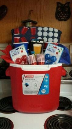 a red and white stove top with an ice bucket filled with food