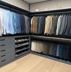 the closet is full of men's shirts and pants