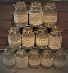 there are many jars with lace on them