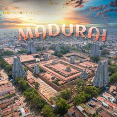 an aerial view of madurai with the sun setting in the background and buildings surrounding it