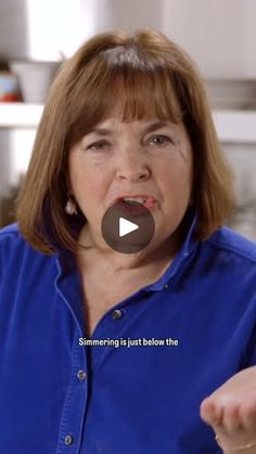 a woman in blue shirt pointing at something