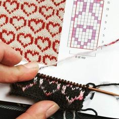 someone is stitching the pattern on a piece of knitted material with scissors and yarn