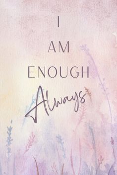 i am enough always written on the side of a wall with flowers and grass around it