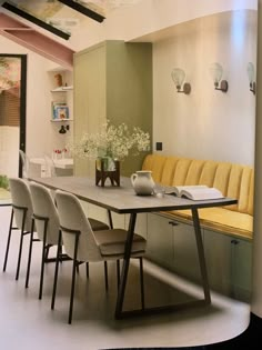 a long table with chairs around it in a room