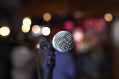 a microphone with blurry lights in the background