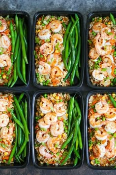 six plastic trays filled with shrimp, rice and veggies covered in sauce