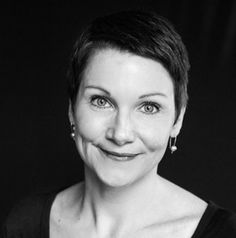 a black and white photo of a woman smiling