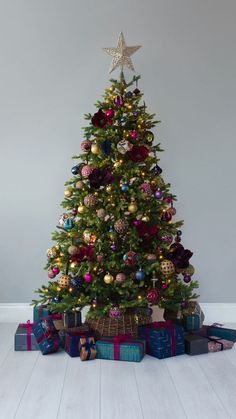 a christmas tree with presents under it