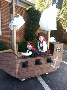 two children dressed up as pirates in a boat