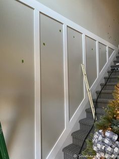 a christmas tree sitting on top of a set of stairs next to a green ladder