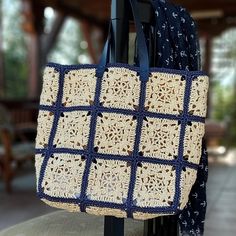 a crocheted tote bag hanging on a rack