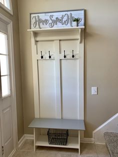 an entryway with a bench and coat rack