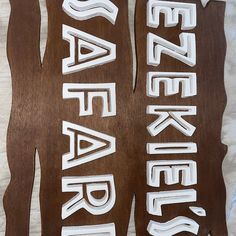 two wooden signs with white letters on them