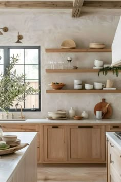 a kitchen filled with lots of wooden shelves