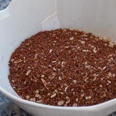 a white bowl filled with food on top of a table