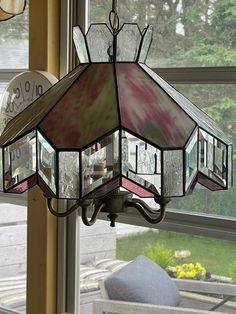 a stained glass chandelier hanging from a window