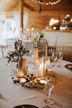 the table is set with candles and flowers