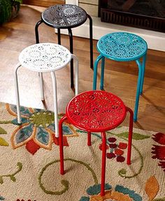 three stools sitting on top of a rug in front of a fireplace