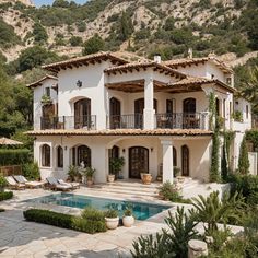 a large house with a pool in front of it