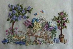 an embroidered piece of cloth with flowers and a horse drawn carriage