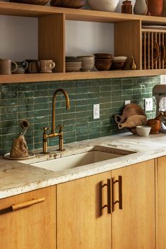 a kitchen with green tile backsplash and wooden cabinets