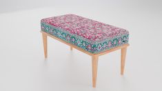 a small wooden bench with a colorful floral seat cover on it's top and legs