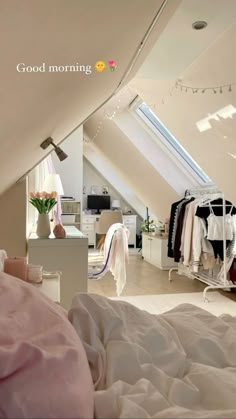 an attic bedroom with clothes hanging on racks