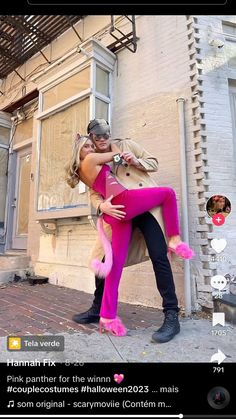 a man and woman dressed in pink posing for a selfie on the street with their arms around each other