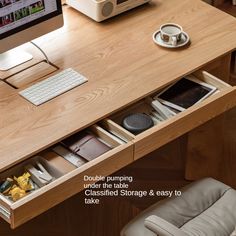 a computer desk with an open drawer underneath it and a keyboard on the other side