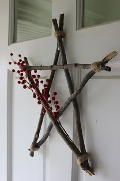 a star made out of sticks with berries on it