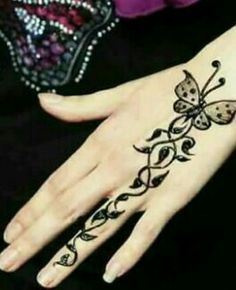 a woman's hand with a butterfly tattoo on it