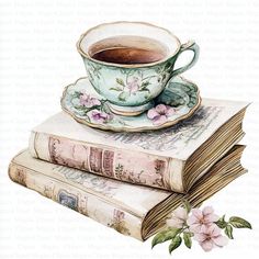 a cup of tea sitting on top of two books with pink flowers next to it