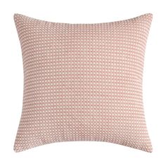 a pink and white pillow with small squares on the front, sitting on a white background