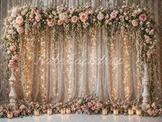 a wedding backdrop with flowers and candles