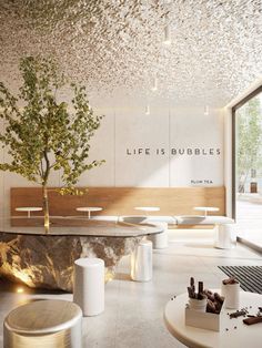 a room with tables, stools and a tree in the center that says life is bubbles