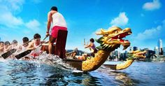 a dragon boat in the water with people on it