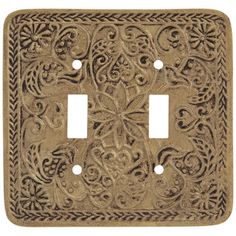 a decorative light switch cover with an intricate design on the front and back plates in antique brass