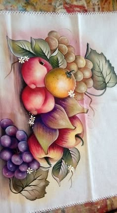 a painting of fruit on a white cloth with green leaves and berries in the center