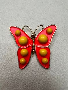 The pin is gold tone metal and has orange enameling for the wings. Bright yellow button dots adorn this bubbly butterfly's wings. Such a happy, groovy pin! This vintage enameled pin is signed "Weiss." Measures 2 by 2 1/4 inches. Excellent condition. Bright Yellow, Butterfly Brooch, Butterfly Wings, Gold Tone Metal, Brooch Pin, Favorite Jewelry, Gold Tones, Dots, Enamel Pins