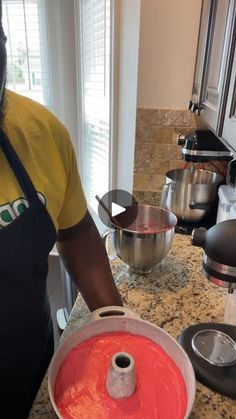 a man in an apron is holding a pan with red liquid on the stove top