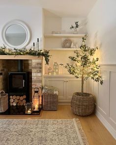 a living room filled with furniture and a fire place next to a tree in a basket