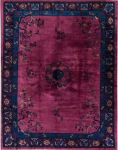 a purple rug with blue and red accents on the center, surrounded by floral designs