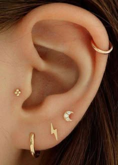 an ear with three different types of piercings on it's sides and one has a