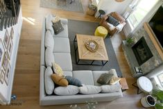 an overhead view of a living room with couches and tables