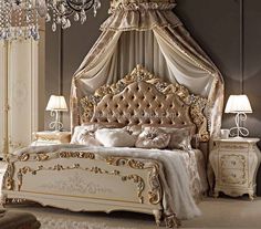 a fancy bedroom with an ornate bed and chandelier