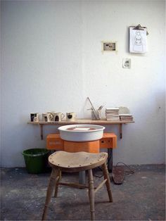 an old wooden chair sitting in front of a table with a white bowl on it